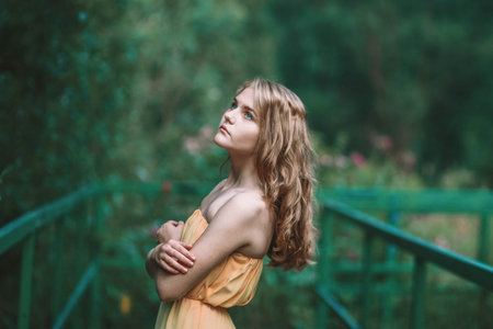 a girl of Slavic appearance in a yellow dress with perfect skin and blue eyes