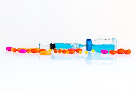 Blue Medical Fluid Inside the Flask and Glass Syringe with a Colorful Medication Around  isolated on a white background の写真素材