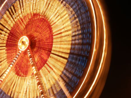nighttime blur of a ferris wheelの写真素材