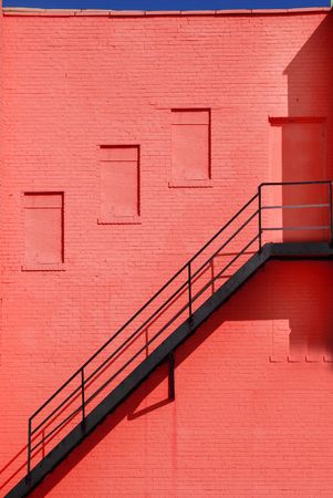 red wall and iron stepsの写真素材
