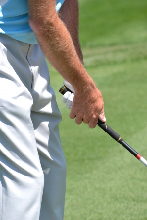 man gripping golf clubの写真素材
