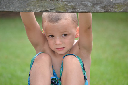 boy climbing a fence