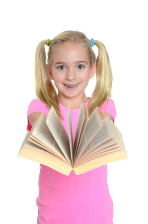 young girl holding an open book isolated white backgroundの写真素材
