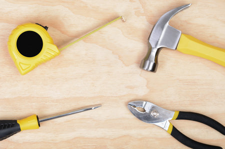 set of tools on wood background hammer, screwdriver,tape measure,pliers,