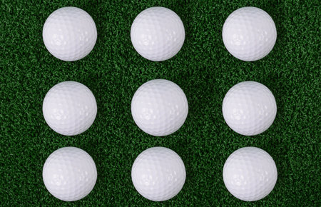 9 golf balls on green grass sport backgroundの写真素材