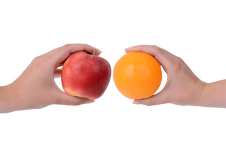 comparing an red apple to an orange difference conceptの写真素材