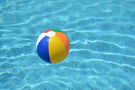 colorful ball floating around a pool summer concept