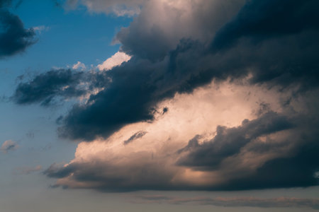 Beautiful evening sky with multi-colored bright clouds. Rain clouds at sunset. High-quality photo