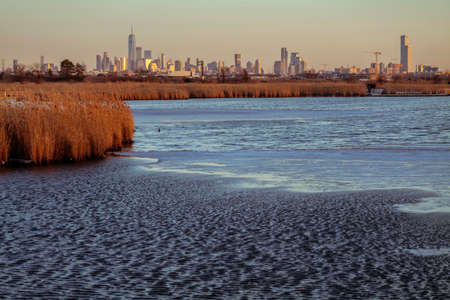 View of the New York City from Richard W. DeKorte Park. Sunny day with blue sky. Pond view. High-quality photoの写真素材