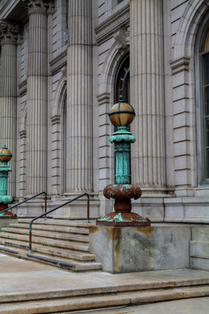 Cast iron, forged antique street lamp with paint peeling off over time in front of the City Hall. High quality photoの写真素材