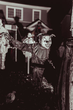 Creepy Halloween Clown Scene with Kissing Booth and Carnival Setup. High quality photo