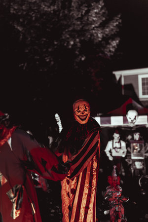 Creepy Halloween Clown Scene with Kissing Booth and Carnival Setup. High quality photo