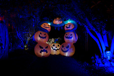 Scary Pumpkin Arch Decoration Illuminated in Blue Halloween Lighting. High quality photoの写真素材