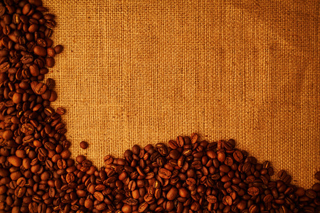 roasted coffee beans on sacking backgroundの写真素材