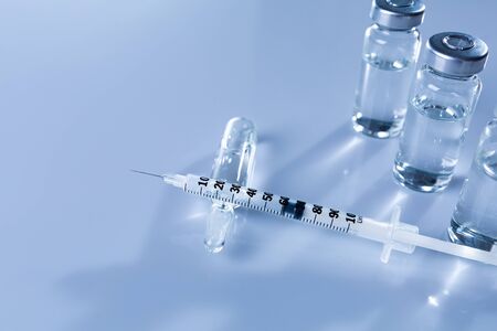 Ampoules, vials, syringe. Medical injection,diseases,health care,diabetes,insulin. Syringe with liquid vaccines preparing to do an injection. Medical equipment. Medical background with copy space.の写真素材