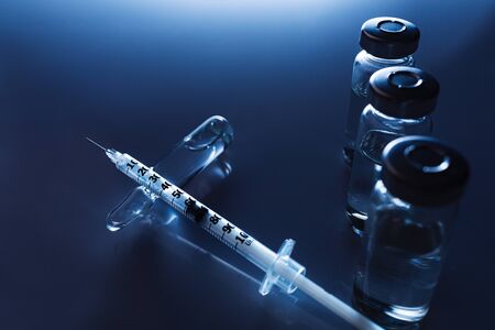 Ampoules, vials, syringe. Medical injection,diseases,health care,diabetes,insulin. Syringe with liquid vaccines preparing to do an injection. Medical equipment. Medical background with copy space.の写真素材