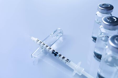 Ampoules, vials, syringe. Medical injection,diseases,health care,diabetes,insulin. Syringe with liquid vaccines preparing to do an injection. Medical equipment. Medical background with copy space.の写真素材