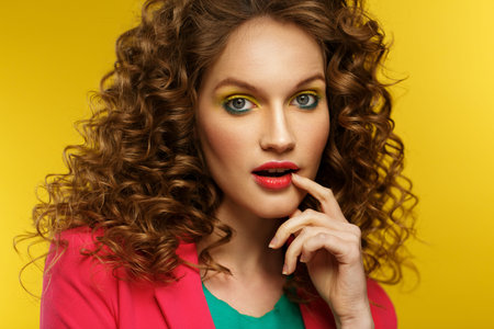 Beautiful women with wide open eyes covering open mouth with hand, being surprised and shocked. Copy...