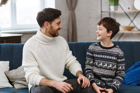 Spending time together. Young father with his little son. Cute boy with dad playing at home. Happy family.の写真素材