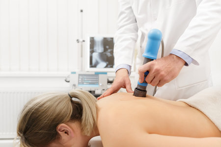 Extracorporeal Shockwave Therapy ESWT.Non-surgical treatment.Physical therapy for neck and back muscles,spine with shock waves.Pain relief, normalization and regeneration,stimulation healing process.の写真素材