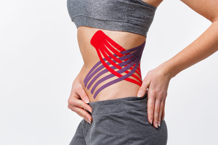 Weight loss concept. Kinesiology taping.Anti-cellulite procedure for slim belly.Close up view of...