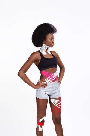 Young smiling female African American athlete on white background.の写真素材
