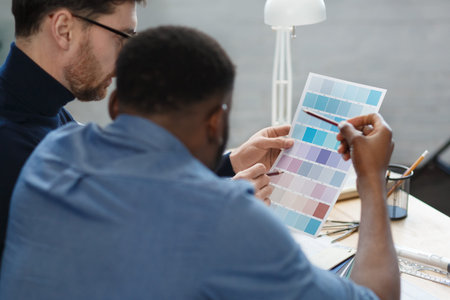 Multiracial engineer team working in office with color palette. Architects select colors for...