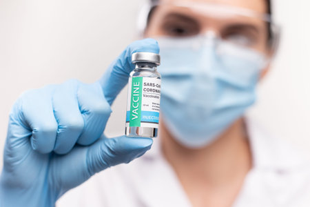 SARS - CoV2 Vaccination concept. Close up vaccine dose. A doctor or nurse in a laboratory holds a...