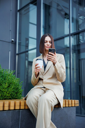 A young brunette girl against the backdrop of a business center, office center. Portrait of a...
