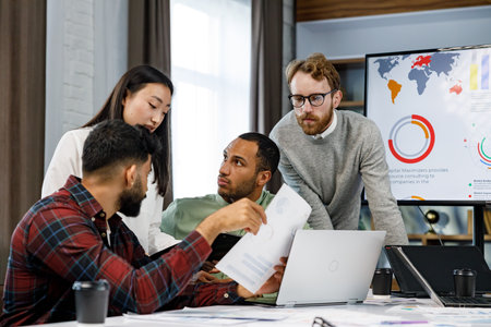 A team of young multinational business people are working on a startup. Business strategy, teamwork.Communication network.Management strategy. Digital transformation. multinational professional staff.の写真素材