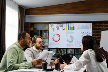 A team of young mixed race businessmen working on a startup. Business strategy, teamwork. Financial crisis. Failed startup. Communication network. multinational professional team.の写真素材