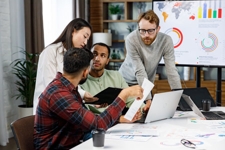 A team of young multinational business people are working on a startup. Business strategy, teamwork.Communication network.Management strategy. Digital transformation. multinational professional staff.の写真素材