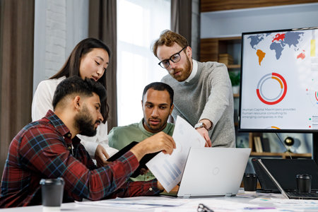 A team of young multinational business people are working on a startup. New generation of startups. Communication network. Management strategy.Digital transformation. multinational professional staffの写真素材