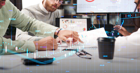 A team of young multinational business people are working on a startup. Analysis of the world market. Communication digital network. Brainstorming, generating business ideas. Application Development.の写真素材
