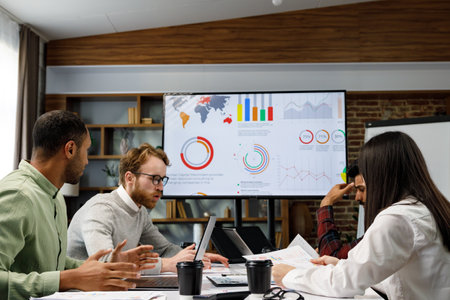 A team of young mixed race businessmen working on a startup. Business strategy, teamwork. Financial crisis. Failed startup. Communication network. multinational professional team.の写真素材