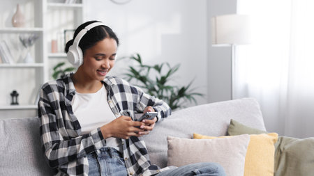Happy young girl with white headphones chilling and listening heの写真素材