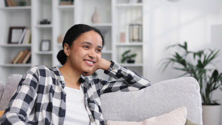 Carefree attractive young African American woman relaxing on sofの写真素材