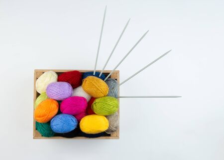 Multicolored balls of wool knitting yarn in the box isolated on white background.Topview, closeup.の写真素材
