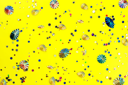 Multi Colored sparkly gemstones on yellow background. Glittery pattern for you perfect design.