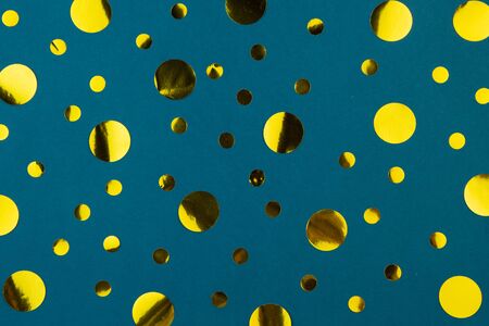 Yellow gold metallic confetti dots on classic blue background.Holiday celebration concept. Festive background.の写真素材