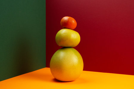 Multicolored geometric composition with various citrus fruits on a triangular background. Front...