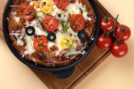 Low-carb keto diet Pizza with mozzarella and tomato crust with cheese filling. Low carb keto diet cake made from almond flour and mozzarella instead of classic pizza. Top view.の写真素材