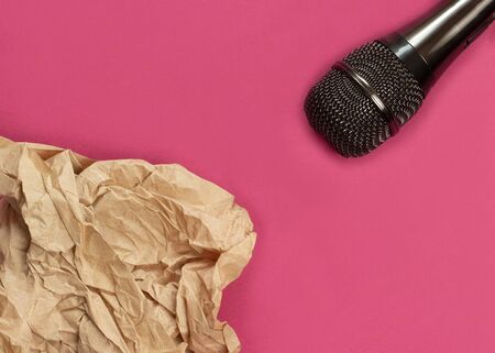 ASMR concept. Specific auditory irritants. Wrinkled paper lie in front of the microphone.の写真素材