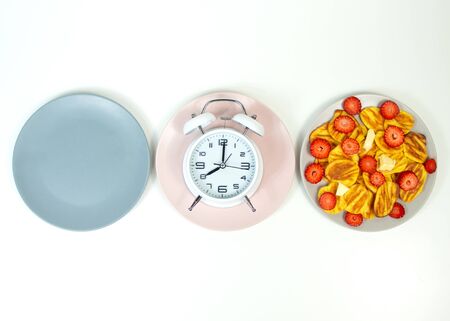 Intermittent fasting concept with empty colorful plates. Time to lose weight , eating control or time to diet concept.の写真素材