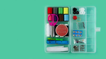 A banner with a sewing kit: scissors, tape measure, thimbles, threads and buttons. Sewing creativity...