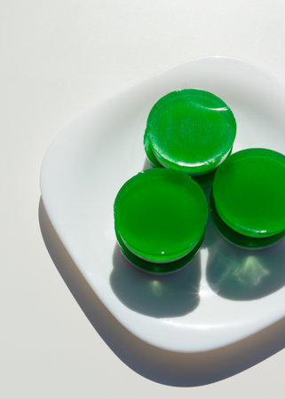 Two-layer jelly made from pandanus leaves and coconut milk. Traditional Thai street food. Lao Wun. Modern minimalist still life. Natural green dye. Pandanus is an Asian vanilla.の写真素材