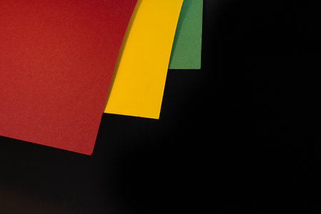 February Black History Month. Abstract Paper geometric black, red, yellow, green background. Copy space, place for your text. Top view.の写真素材