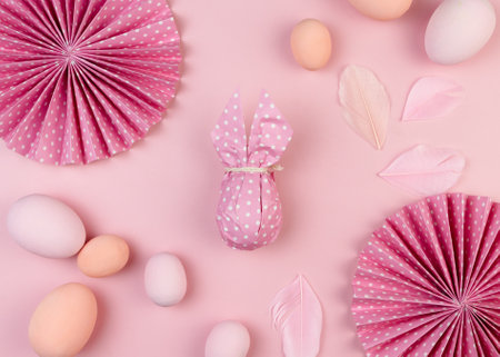 Colorful Easter eggs in pastel colors and decorated with paper flowers. Happy Easter greeting card. Flat layの写真素材