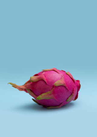 Ripe whole dragon fruit with white flesh. The pink pitaya fruit is low in calories, rich in...
