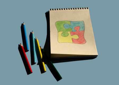 Autism awareness day or month. The drawn puzzle is colored in different colors as a symbol of autism...